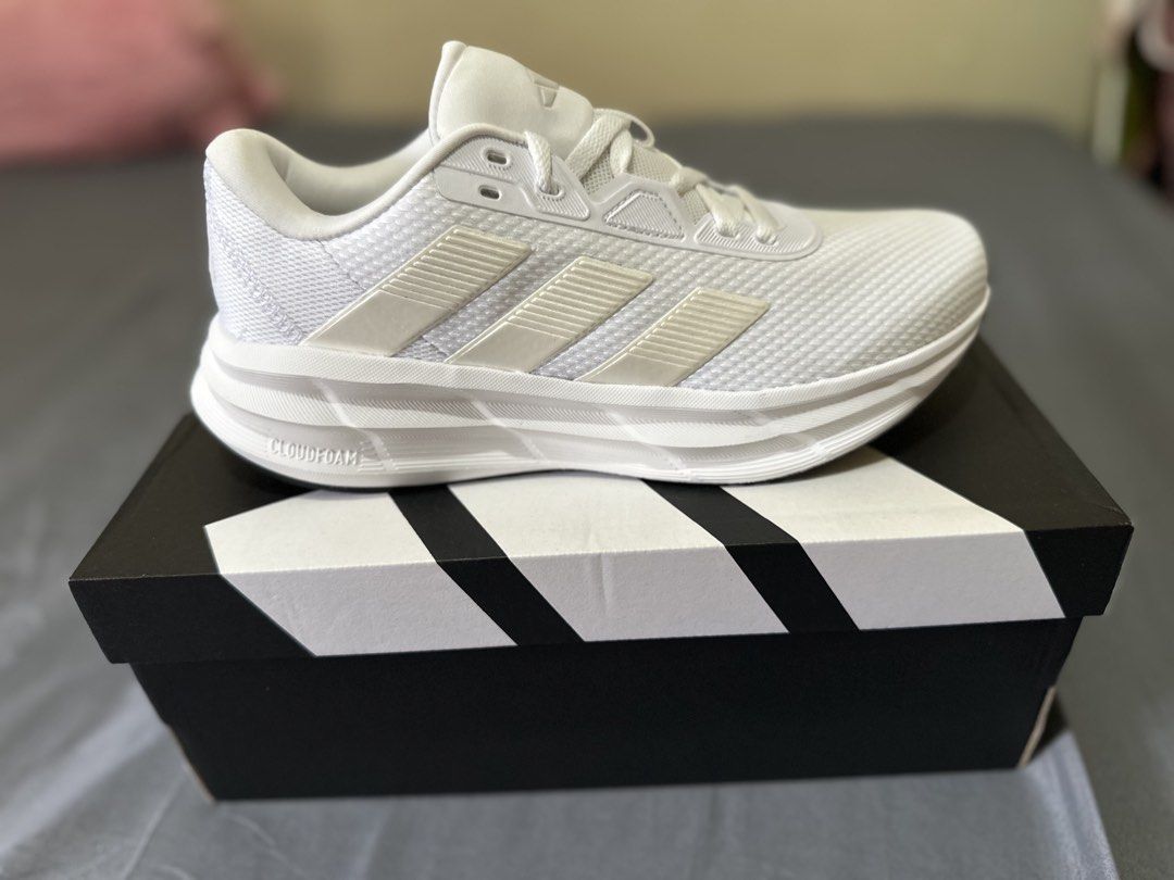 Adidas Galaxy 7W Running Shoes White (Category: Sneakers) located in Manila. Submitted by boldtiger_0f837b (Listing ID 1464582528, Image 3). Description: - White Adidas running shoes - Classic three stripes design - Cloudfoam cushioning for ultimate comfort - Ideal for running and everyday wear - Comes with original box - Size: US 700.