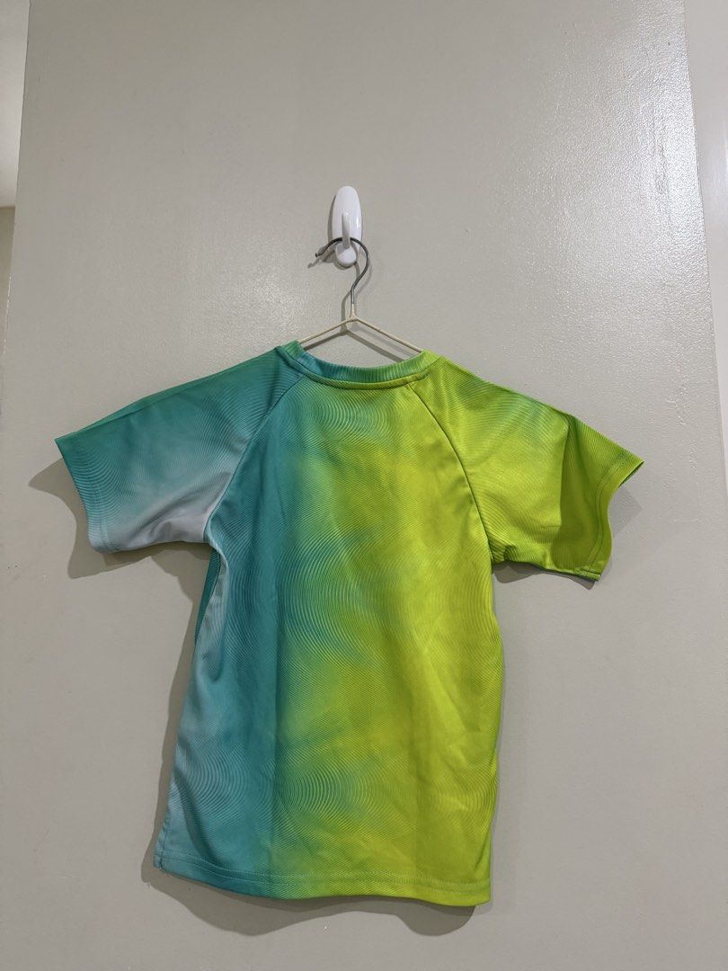 Adidas Kids Drifit Top 3T (Category: Babies & Kids Fashion) located in Subic. Submitted by kittysclosetsale (Listing ID 1464746476, Image 2). Description: - Brand: Adidas - Size: Toddler 3T - Material: 100% breathable polyester - Design: Eye-catching neon green and blue gradient with wavy lines and a large black outline Adidas logo - Style: Crew neck, short sleeves, and tagless comfort interior - Origin: Made in China.