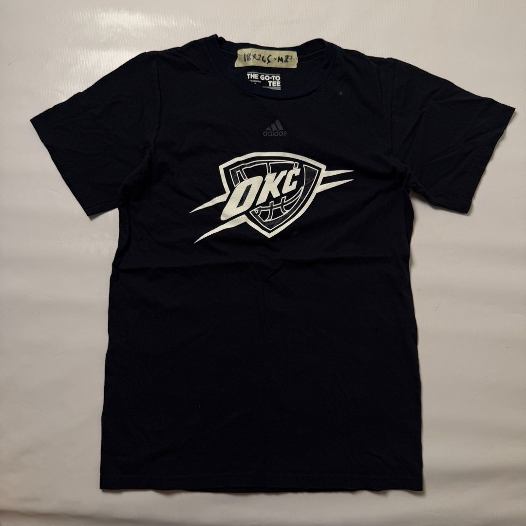 Adidas OKC Thunder Go-To Tee Size S (Category: Tshirts & Polo Shirts ) located in Manila. Submitted by johnedel_james (Listing ID 1464685974, Image 1). Description: - Navy blue Adidas t-shirt - Features official OKC Thunder logo - Made from comfortable cotton - Tag reads 'The Go-To Tee' - Size: Small (S) - Ideal for any Oklahoma City Thunder or basketball enthusiast.