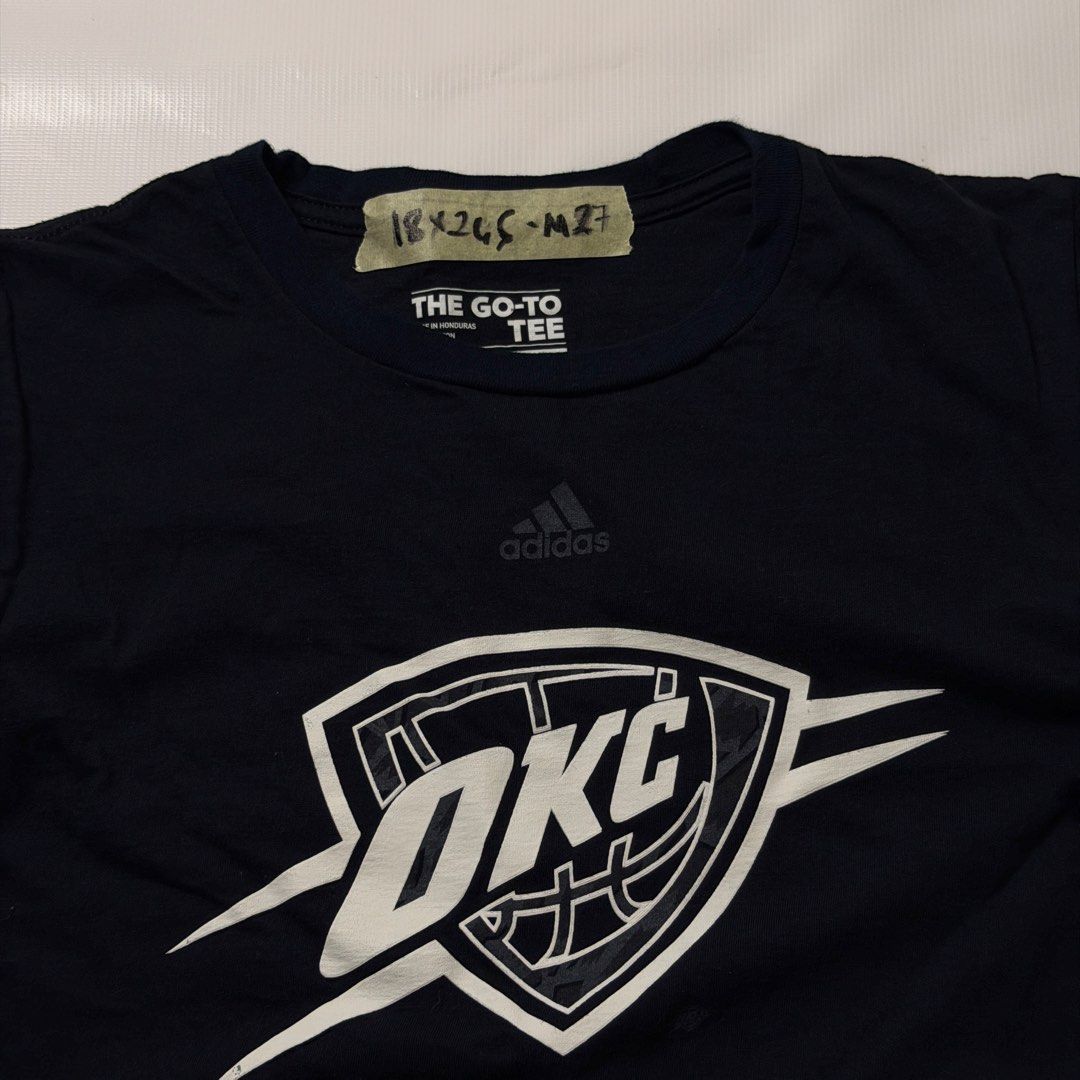 Adidas OKC Thunder Go-To Tee Size S (Category: Tshirts & Polo Shirts ) located in Manila. Submitted by johnedel_james (Listing ID 1464685974, Image 2). Description: - Navy blue Adidas t-shirt - Features official OKC Thunder logo - Made from comfortable cotton - Tag reads 'The Go-To Tee' - Size: Small (S) - Ideal for any Oklahoma City Thunder or basketball enthusiast.