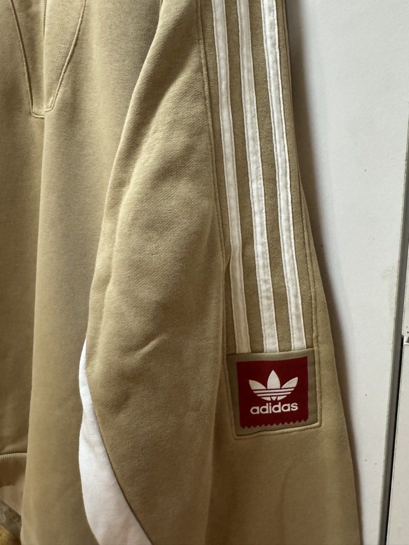 Adidas Quarter Zip Sweatshirt Beige (Category: Coats, Jackets and Outerwear) located in Manila. Submitted by quintessesommerset (Listing ID 1464682102, Image 3). Description: - Beige Adidas sweatshirt 24x27 - White stripes on sleeves - Quarter zip neckline - Classic Adidas logo on sleeve - Red and white paneling on sides - Ideal for casual wear.