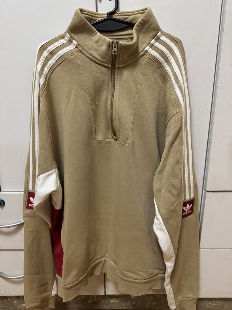 Adidas Quarter Zip Sweatshirt Beige (Category: Coats, Jackets and Outerwear) located in Manila. Submitted by quintessesommerset (Listing ID 1464682102, Image 1). Description: - Beige Adidas sweatshirt 24x27 - White stripes on sleeves - Quarter zip neckline - Classic Adidas logo on sleeve - Red and white paneling on sides - Ideal for casual wear.