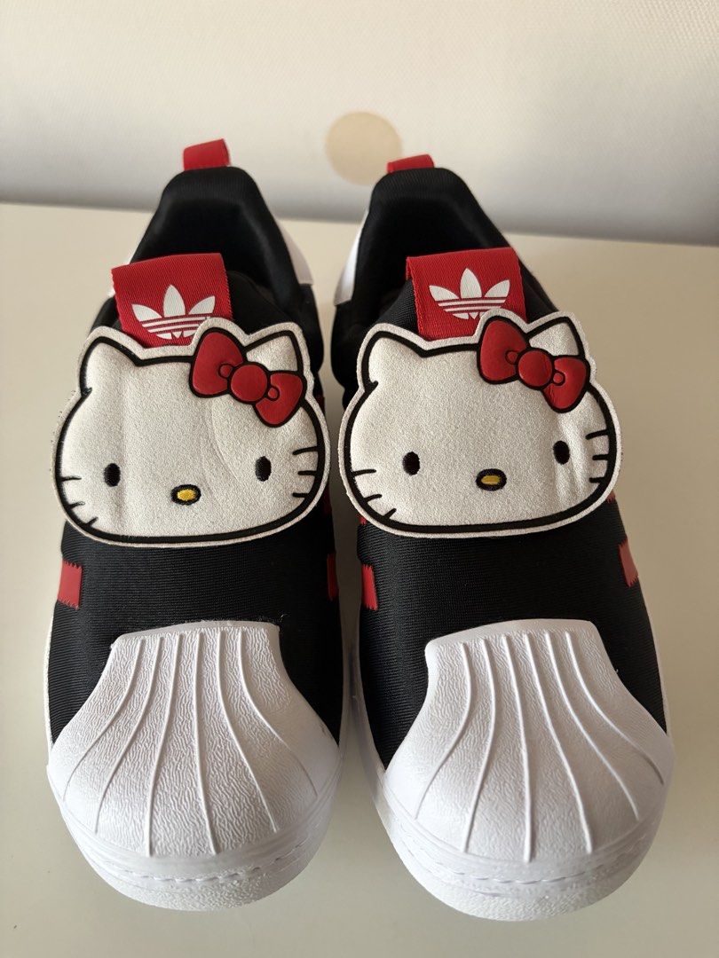 Adidas Superstar 360 Hello Kitty and Friends (Category: Babies & Kids Fashion) located in Pasig City. Submitted by jackiedla (Listing ID 1464765683, Image 1). Description: - Brand: Adidas Superstar x Kitty and Friends - Colorway: Core Black and Vivid Red - Size: Kids US 1.5 / UK 1 / French 33 - Design: Iconic shell toe with oversized Kitty face patches and hexagonal outsoles - Condition: Complete with original character-printed shoebox - Perfect 