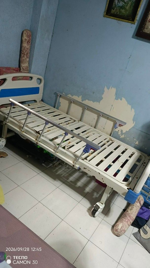 Adjustable Hospital Bed with Side Rails and Walker (Category: Medical Supplies & Tools) located in Valenzuela. Submitted by thrift_ko_cedie222 (Listing ID 1464605732, Image 2). Description: - Hospital bed with adjustable side rails - Includes walker with seat and wheels - Bed frame: Metal with blue and white accents - Walker: Chrome-plated metal - Ideal for home care needs - Selling as a complete set.