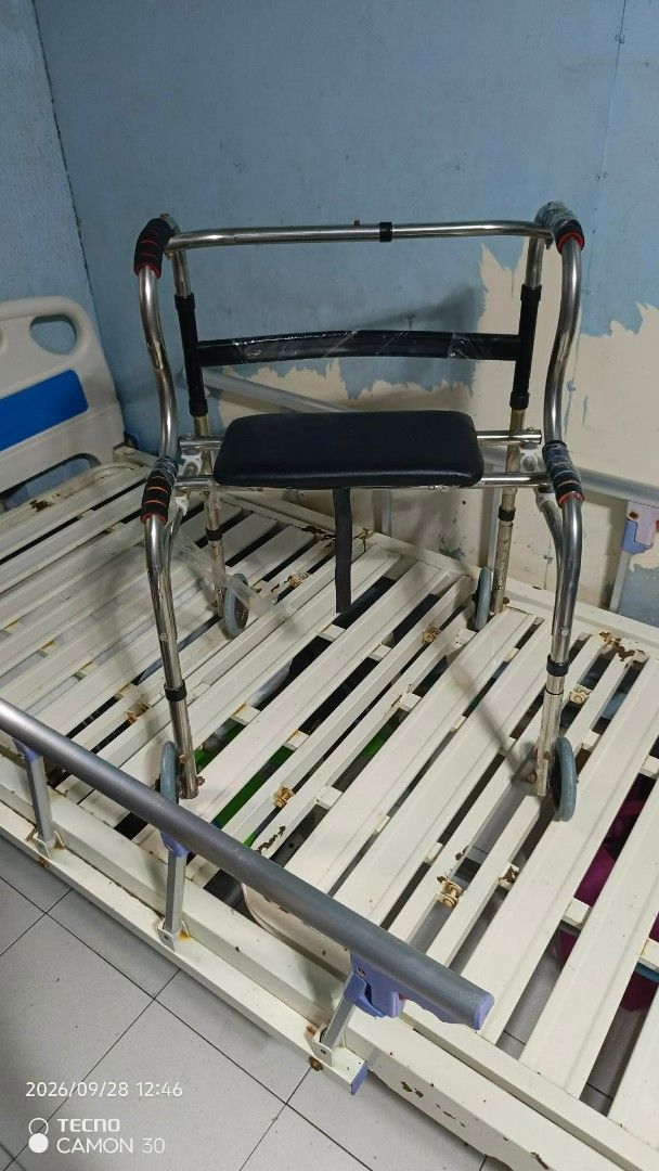 Adjustable Hospital Bed with Side Rails and Walker (Category: Medical Supplies & Tools) located in Valenzuela. Submitted by thrift_ko_cedie222 (Listing ID 1464605732, Image 3). Description: - Hospital bed with adjustable side rails - Includes walker with seat and wheels - Bed frame: Metal with blue and white accents - Walker: Chrome-plated metal - Ideal for home care needs - Selling as a complete set.