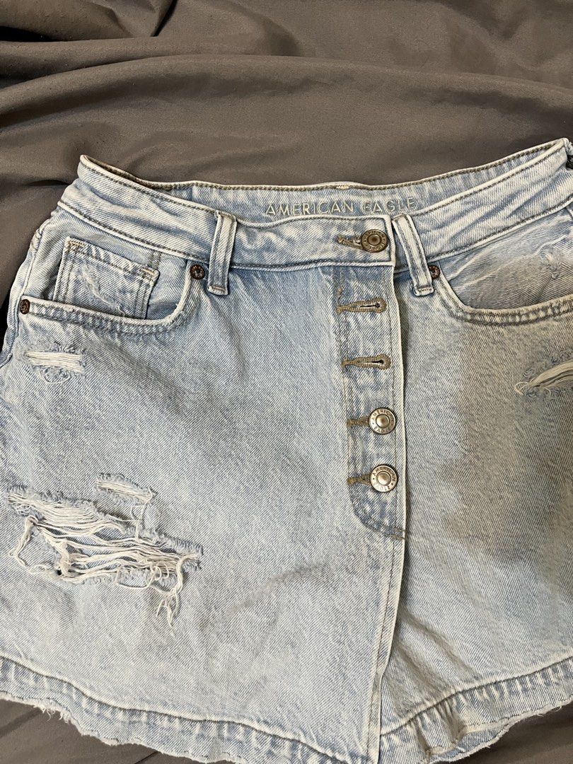 American Eagle Distressed Button-Front Denim Shorts (Category: Shorts) located in Taguig. Submitted by lovestoreph (Listing ID 1464712881, Image 1). Description: Light wash denim skort from American Eagle. High-waisted style with a button-fly front. Trendy distressed details with frayed rips on the front. Classic five-pocket design plus belt loops. Super cute and easy to throw on with a simple tee or tank top for summer days..