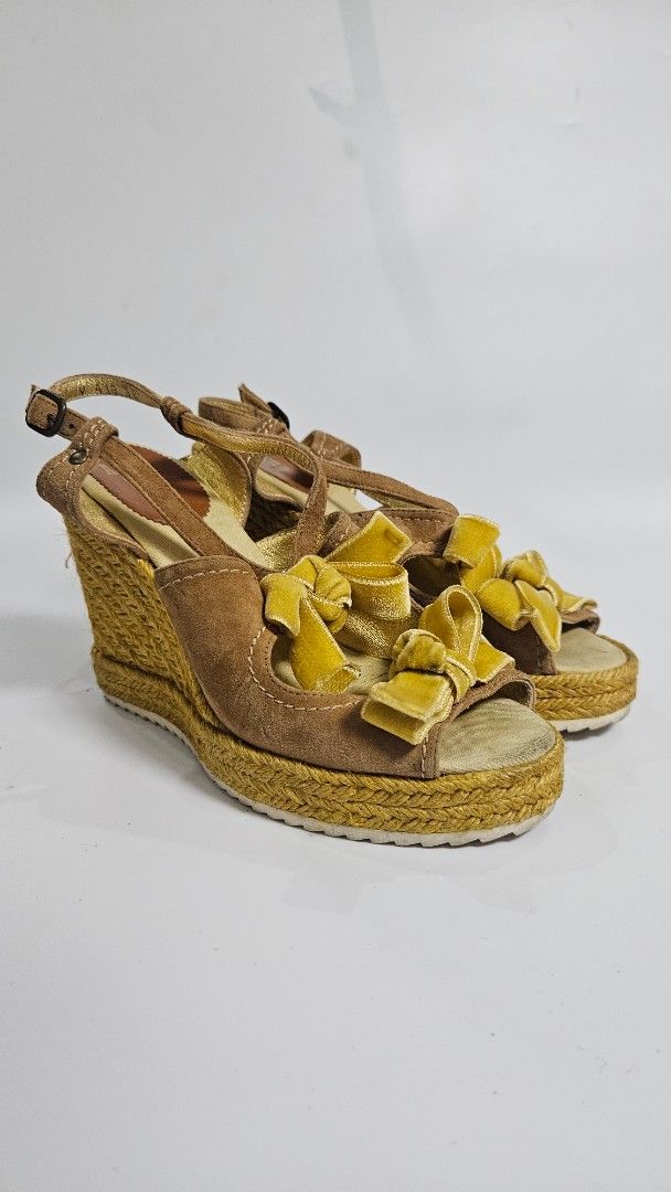 Anna Sui World Wedge Espadrille Sandals (Category: Wedges) located in Alfonso. Submitted by jbcamet (Listing ID 1464604762, Image 1). Description: - Brand: Anna Sui - Type: Wedge Sandals - Color: Brown suede straps with yellow ruffle details - Sole: Espadrille - Closure: Buckle - Size: 38 - Style: Great for summer outfits.