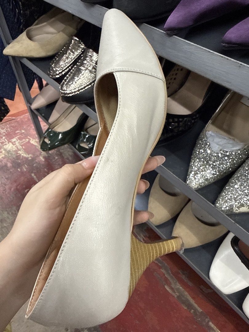 Ann's White Pointed Toe Kitten Heels Size 38 (Category: Heels) located in Manila. Submitted by fastlion.584bdf (Listing ID 1464735480, Image 2). Description: - Style: Pointed toe kitten heel pumps - Color: White - Size: 38 (Made in Taiwan) - Comfort: Branded insoles with perforated cushioning - Condition: Moderate wear on soles/insoles, minor scuffs on leather upper - Ideal for: Work, formal events, and easy slip-on wear.
