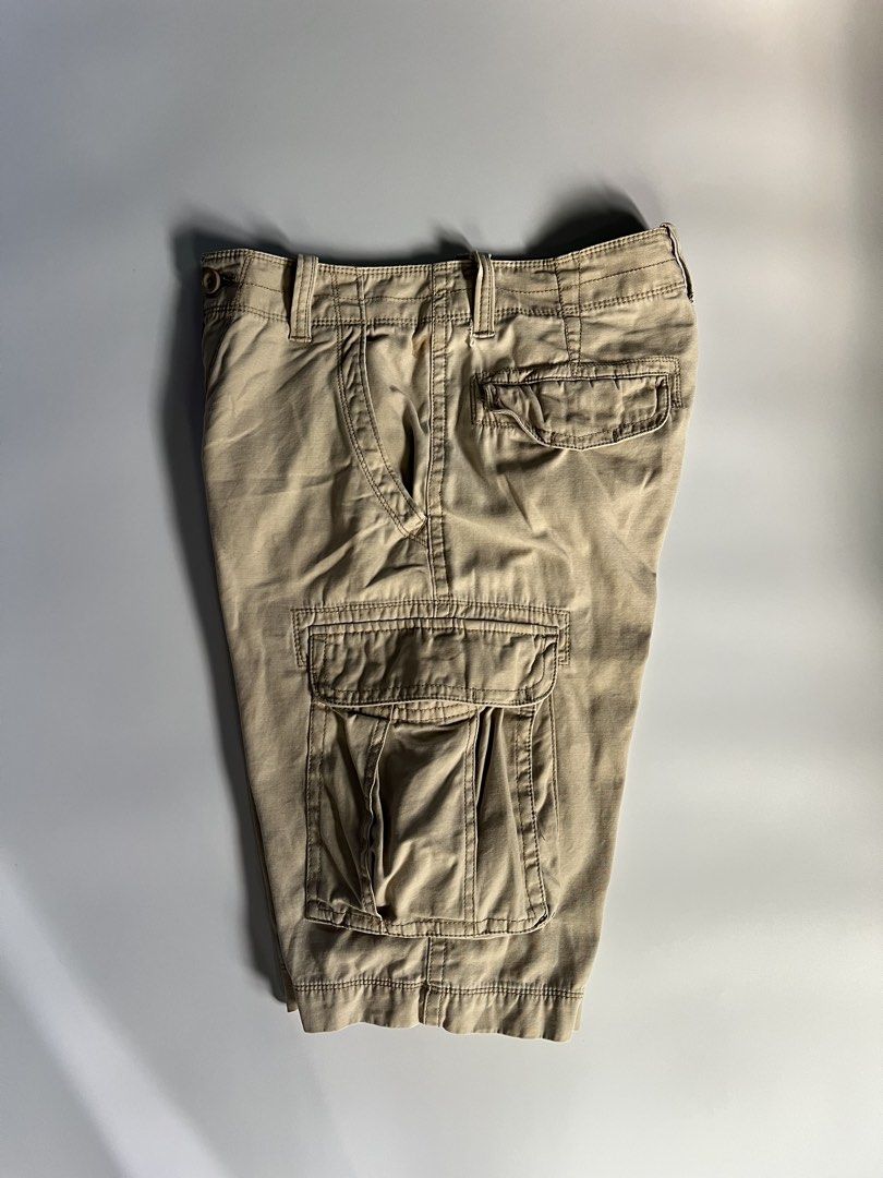 Arizona Khaki Cargo Shorts Size 29 (Category: Shorts) located in Baler. Submitted by allthrifted31 (Listing ID 1464732533, Image 3). Description: - Brand/Item: Arizona Khaki Cargo Shorts - Size: 29 - Material: 100% Cotton (Made in Bangladesh) - Design: Multiple pockets on front, back, and sides with olive green waistband lining - Condition: Good, with a small stain near the front belt loop (please check close-up photo).