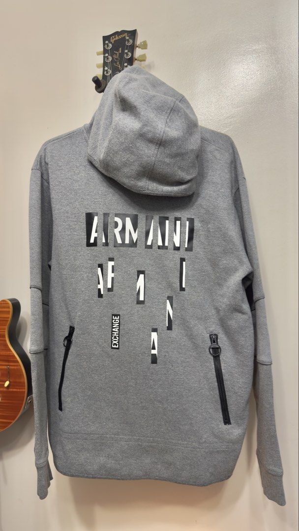 Armani Exchange Grey Hoodie (Category: Coats, Jackets and Outerwear) located in Balanga. Submitted by bluesero (Listing ID 1464627161, Image 2). Description: - Grey Armani Exchange hoodie - Features AX logo graphic on front and back - Side zip pockets for convenience - Made from a comfortable cotton blend with elastic details - size W21.5in X 27.5in.