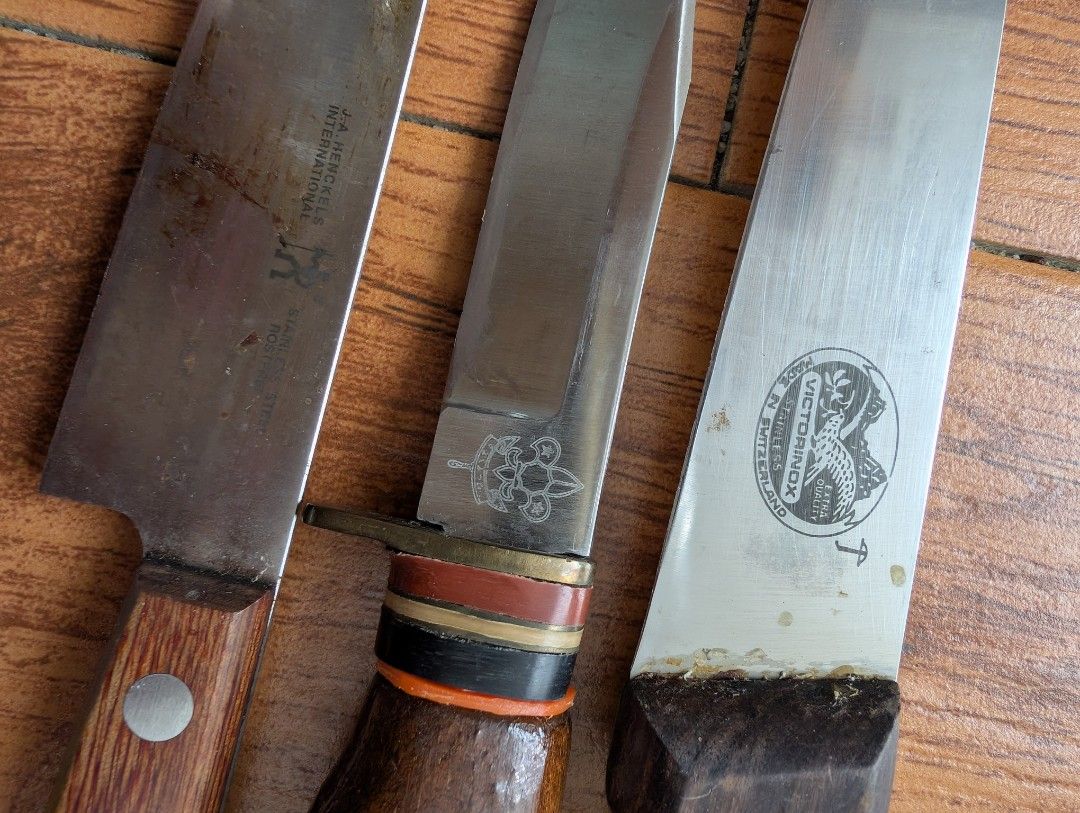Assorted Vintage Kitchen and Utility Knives Collection (Category: Knives & Chopping Boards) located in Naga. Submitted by kenshin78 (Listing ID 1464734214, Image 2). Description: - Bundle of 6 various knives + 1 leather sheath - Includes trusted brands: J.A. Henckels International and Victorinox - Features several Japanese traditional woodworking and fishing knives with wooden handles - Blade material: Mix of stainless steel and carbon steel - Co