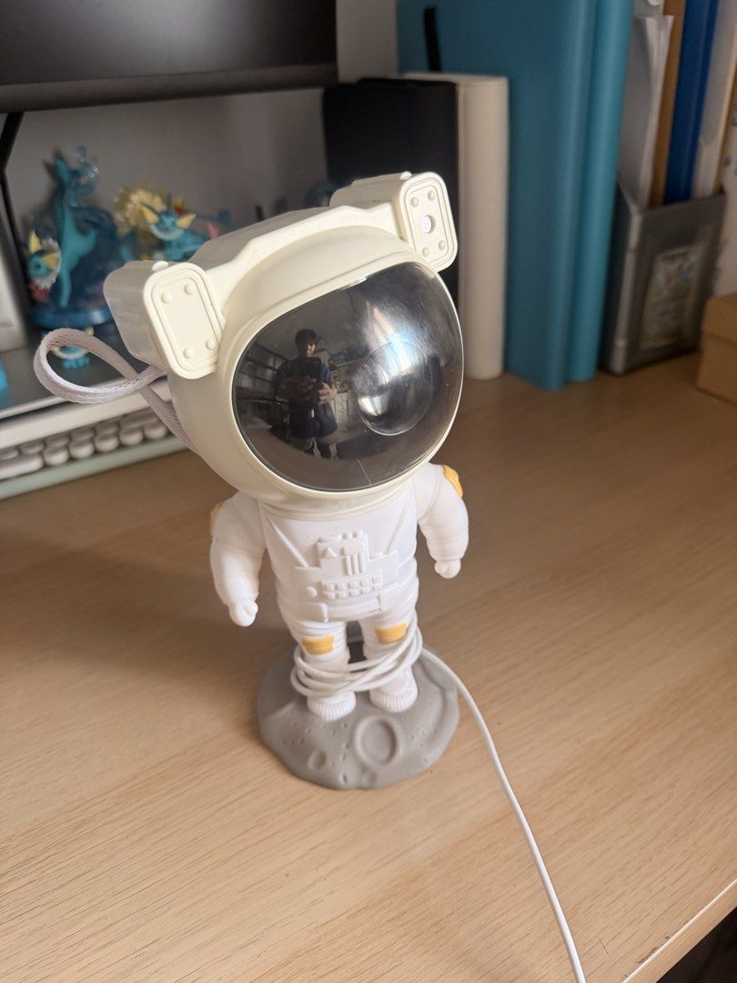 Astronaut Projector Lamp with Moon Base (Category: Lighting) located in Manila. Submitted by ellede32655 (Listing ID 1464618675, Image 1). Description: - Adorable astronaut design - Projects light - Sits on a moon-shaped base - Adjustable head for custom lighting - USB powered (cable included) - Ideal for kids' rooms or as a unique night light - In excellent working condition.