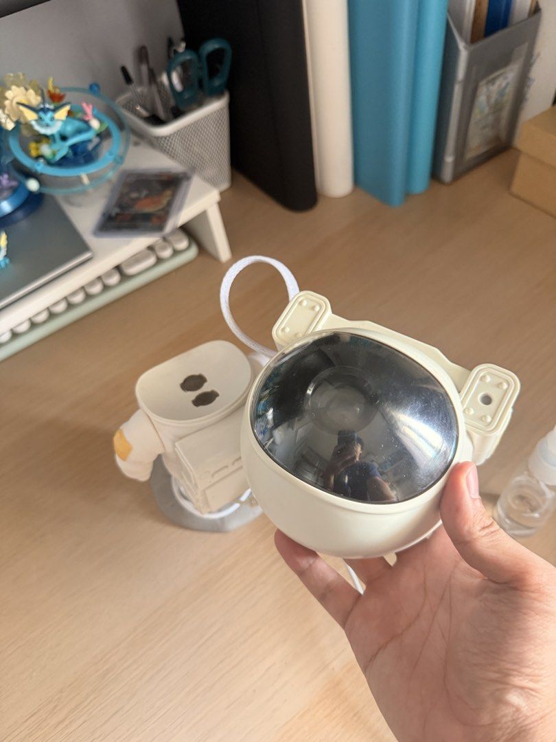 Astronaut Projector Lamp with Moon Base (Category: Lighting) located in Manila. Submitted by ellede32655 (Listing ID 1464618675, Image 3). Description: - Adorable astronaut design - Projects light - Sits on a moon-shaped base - Adjustable head for custom lighting - USB powered (cable included) - Ideal for kids' rooms or as a unique night light - In excellent working condition.