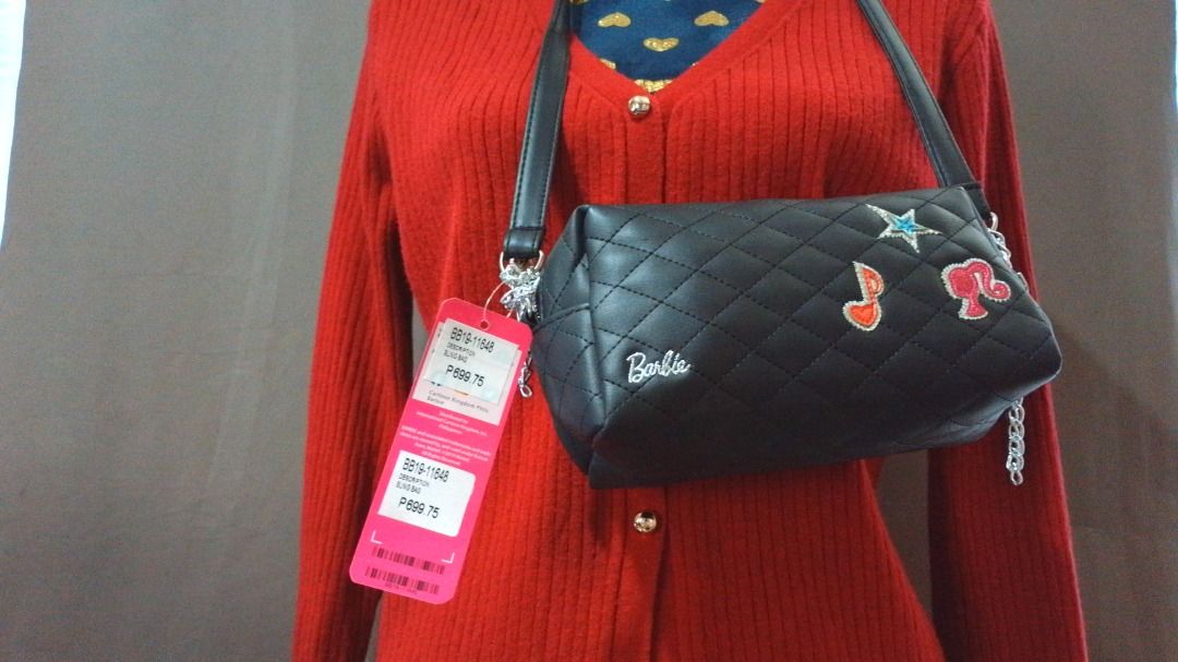 Authentic Barbie Quilted Black Crossbody Bag (Category: Cross-body Bags) located in Caloocan City. Submitted by 11eleven.shop (Listing ID 1464583970, Image 1). Description: - Cute black quilted crossbody bag - Adorned with fun Barbie graphic charms (star, music note) - Interior lining features a cool Barbie print - Equipped with a stylish chain strap (adjustable) - Secure zip closure - Perfect gift for any Barbie enthusiast!.
