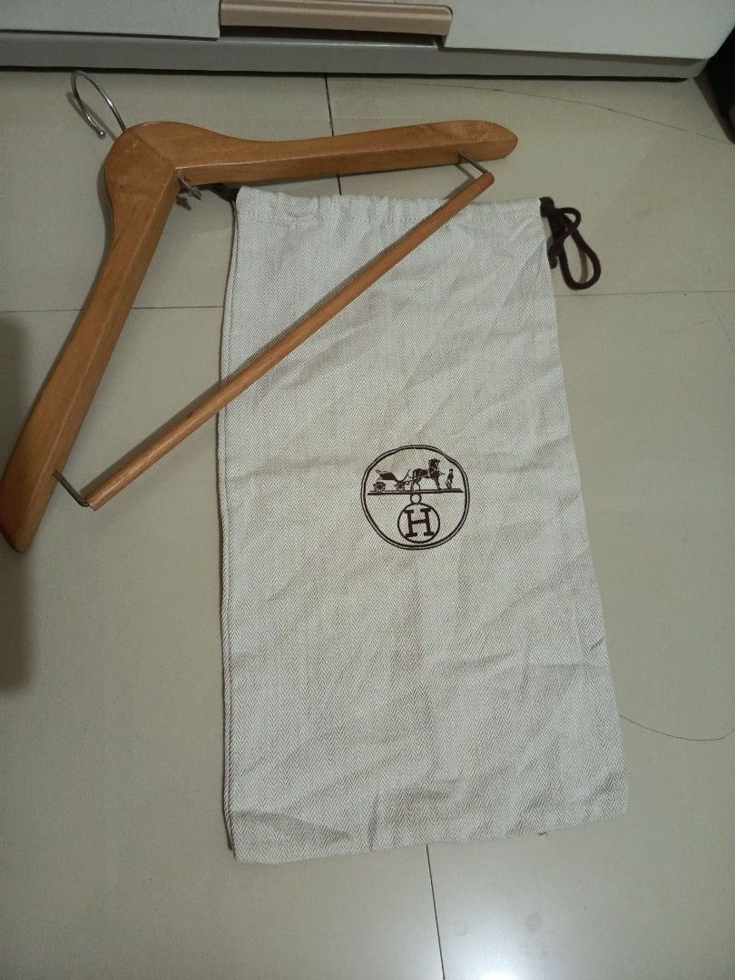 Authentic HERMES Dust Bag with Wooden Hanger (Category: Tote Bags) located in Irosin. Submitted by whanchore55263 (Listing ID 1464572769, Image 1). Description: - Authentic Hermes dust bag with iconic embroidered logo. - Sturdy wooden hanger with metal hook. - Ideal for protecting and organizing luxury bags and accessories. 16x9 inch .