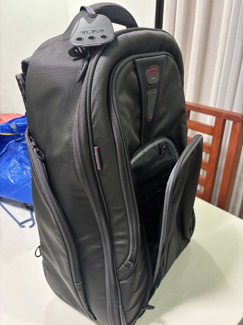 Authentic Tumi Tech Backpack Luggage with Wheels and Handle (Category: Backpacks) located in San Fernando. Submitted by destinydeals04 (Listing ID 1464572537, Image 2). Description: - Original Black Tumi Tech backpack - Features wheels and retractable handle for easy travel - Padded shoulder straps for comfort - Multiple compartments for excellent organization - Ideal for both work and travel needs.
