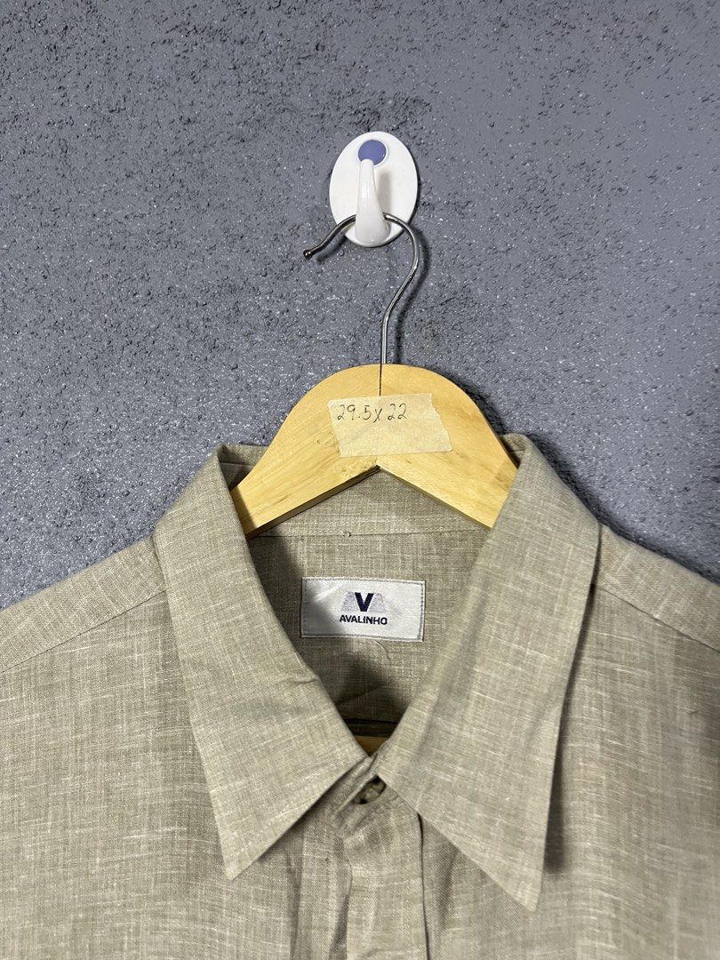 AVALINHO Men's Beige Short Sleeve Linen Blend Button-Down Shirt (Category: Tshirts & Polo Shirts ) located in Famy. Submitted by basicthrifted (Listing ID 1464704607, Image 3). Description: - Brand: AVALINHO - Style: Short-sleeve button-down shirt with classic collar and single chest pocket - Color: Versatile beige with subtle textured weave - Material: 55% linen, 45% polyester (lightweight and breathable) - Fit: Standard fit - Measurements: 22" 