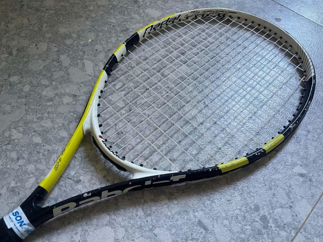 Babolat Nadal Junior Tennis Racket (Category: Racket and Ball Sports) located in Caloocan City. Submitted by oliveestr95391 (Listing ID 1464576358, Image 1). Description: Head Size: 680 sq cm / 105 sq in Length: 25 inches Weight: 240g unstrung Target age: 9-10 years old, 130-140cm height Color: Yellow-Black Nadal design Material: Aluminum frame This is the bigger junior size before moving to adult 27" rackets. The 680sq cm head makes it more forg
