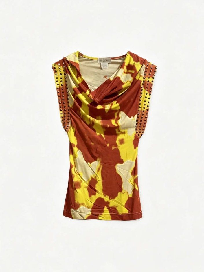 BABY PHAT (Category: Blouses) located in Davao. Submitted by sart0ria85 (Listing ID 1464740251, Image 1). Description: This archival brand of Kimora Lee Simons is a combo of tie dye and cow skin print only in rusty red and yellow. Almost sun figurative adding the metals on the sleeves for a fierce summer look! 95% COTTON 5% ELASTANE MADE IN CHINA 🇨🇳 MEDIUM. Size 6 EXCELLENT CONDITION (92/100).