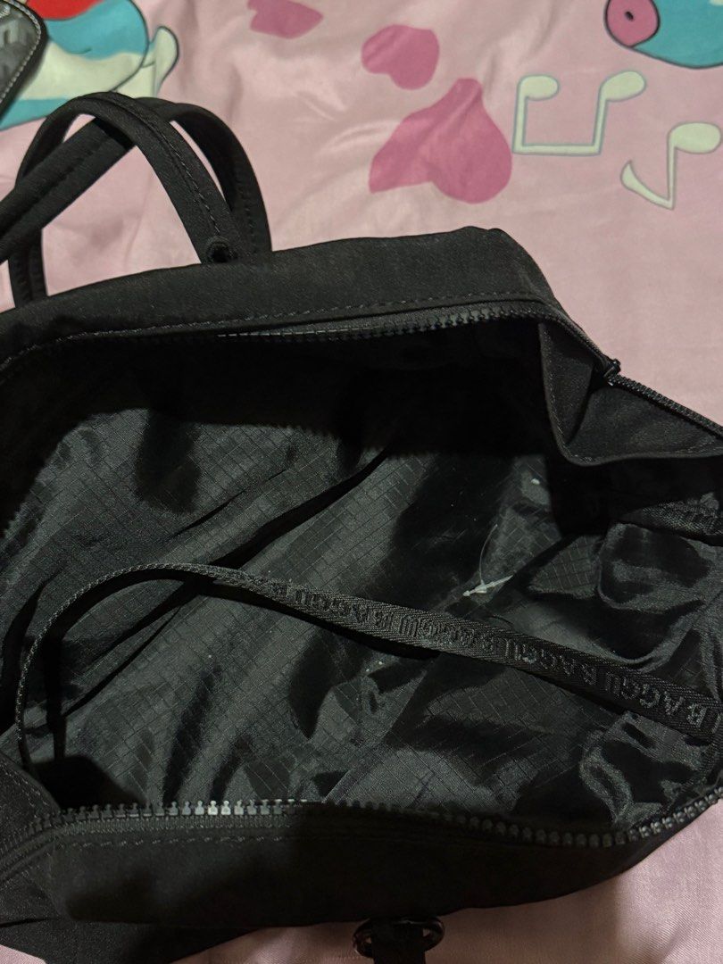 BAGGU Black Nylon Pouch Bag (Category: Purses & Pouches) located in Manila. Submitted by medv27 (Listing ID 1464601854, Image 2). Description: - Brand: Baggu - Color: Black - Material: Nylon - Closure: Zippered - Interior: Patterned lining - Straps: Black, cross over the top - Ideal for: Carrying small essentials.