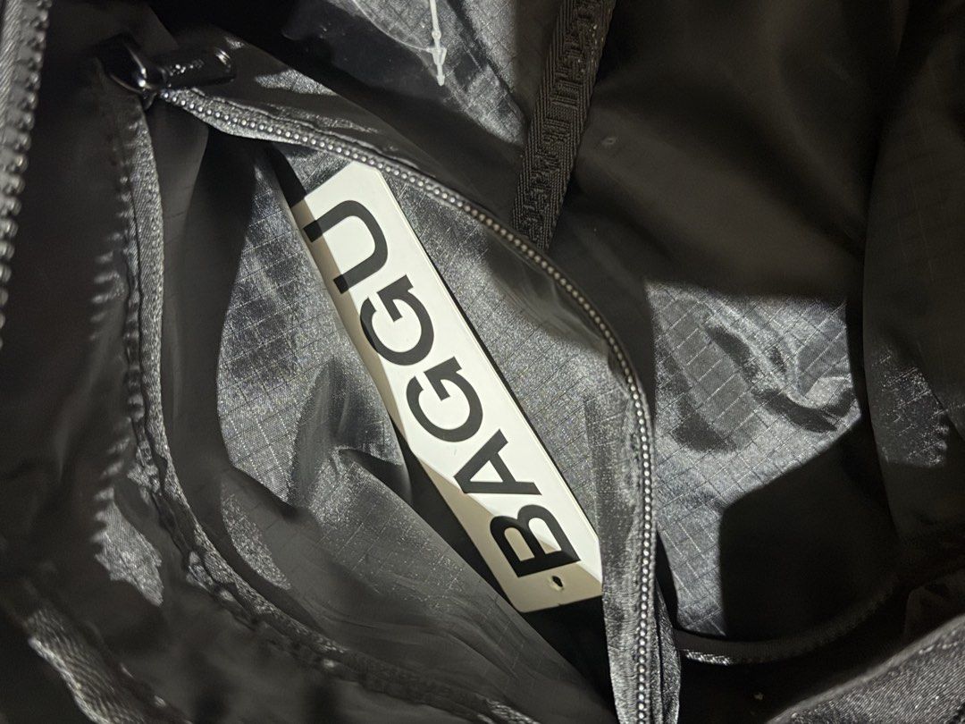 BAGGU Black Nylon Pouch Bag (Category: Purses & Pouches) located in Manila. Submitted by medv27 (Listing ID 1464601854, Image 3). Description: - Brand: Baggu - Color: Black - Material: Nylon - Closure: Zippered - Interior: Patterned lining - Straps: Black, cross over the top - Ideal for: Carrying small essentials.