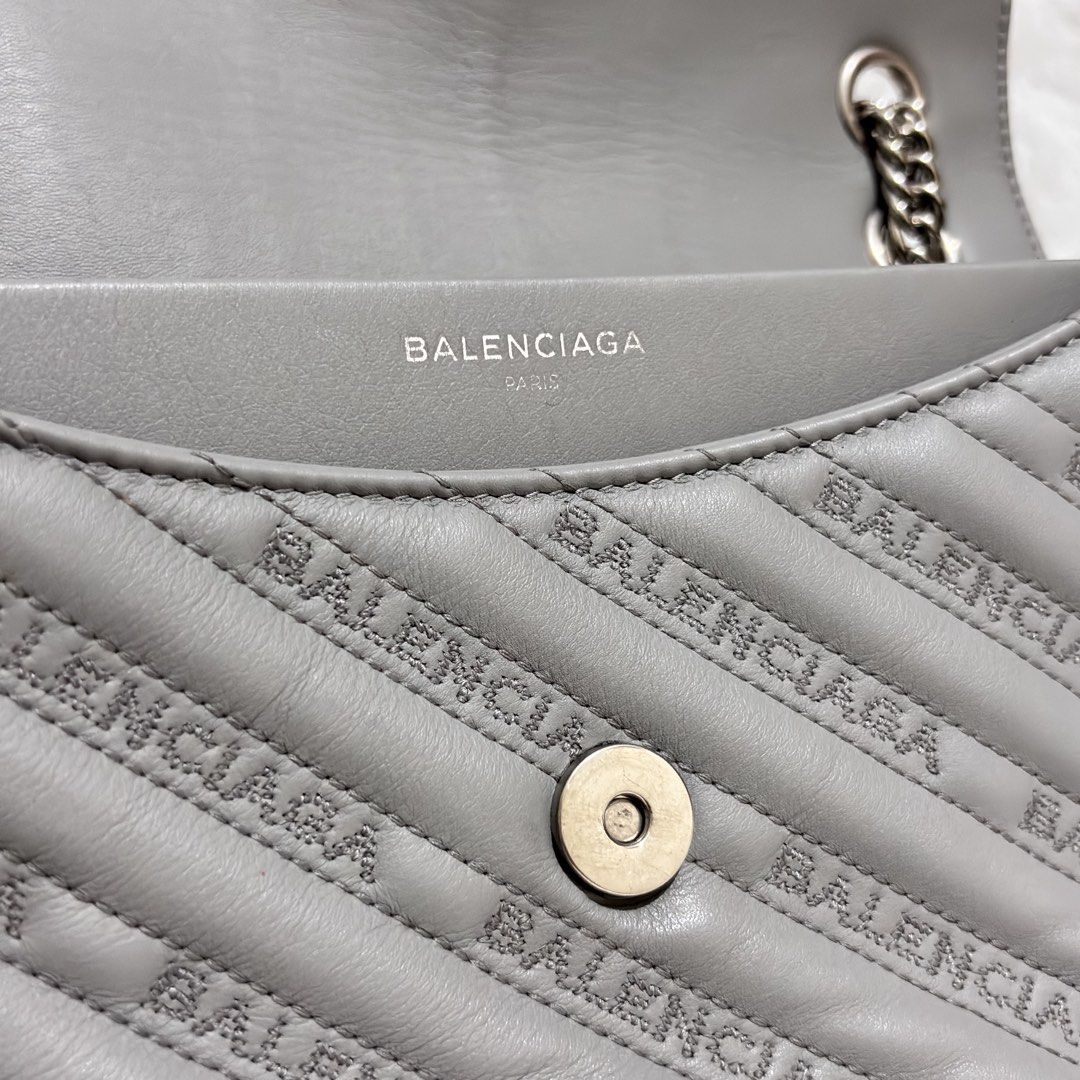 Balenciaga BB Round Medium Quilted Monogram Chain Flap Bag (Category: Luxury Bags & Wallets) located in Quezon City. Submitted by leens.preloved (Listing ID 1462629508, Image 3). Description: - Grey Balenciaga shoulder bag - All-over logo print and quilted detailing - Chunky silver-tone chain strap - Smaller leather strap included - Iconic BB logo on the front flap - Versatile for day or night use.