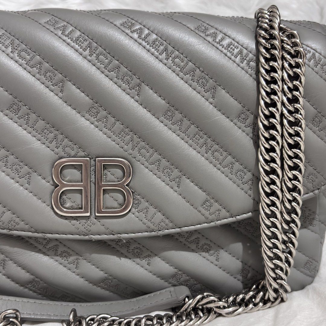 Balenciaga BB Round Medium Quilted Monogram Chain Flap Bag (Category: Luxury Bags & Wallets) located in Quezon City. Submitted by leens.preloved (Listing ID 1462629508, Image 2). Description: - Grey Balenciaga shoulder bag - All-over logo print and quilted detailing - Chunky silver-tone chain strap - Smaller leather strap included - Iconic BB logo on the front flap - Versatile for day or night use.