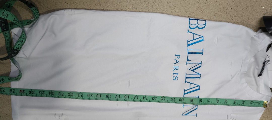 Balmain Paris White Distressed Logo T-Shirt (Category: Tshirts & Polo Shirts ) located in Zamboanga. Submitted by benbryanab14320 (Listing ID 1464644959, Image 3). Description: - Authentic Balmain Paris white t-shirt - Features iconic blue Balmain Paris logo - Stylish distressed details all over - Size: Large (L) - Origin: Made in PRC - Care Instructions: Hand wash separately inside out. Do not bleach or tumble dry. -Unisex.