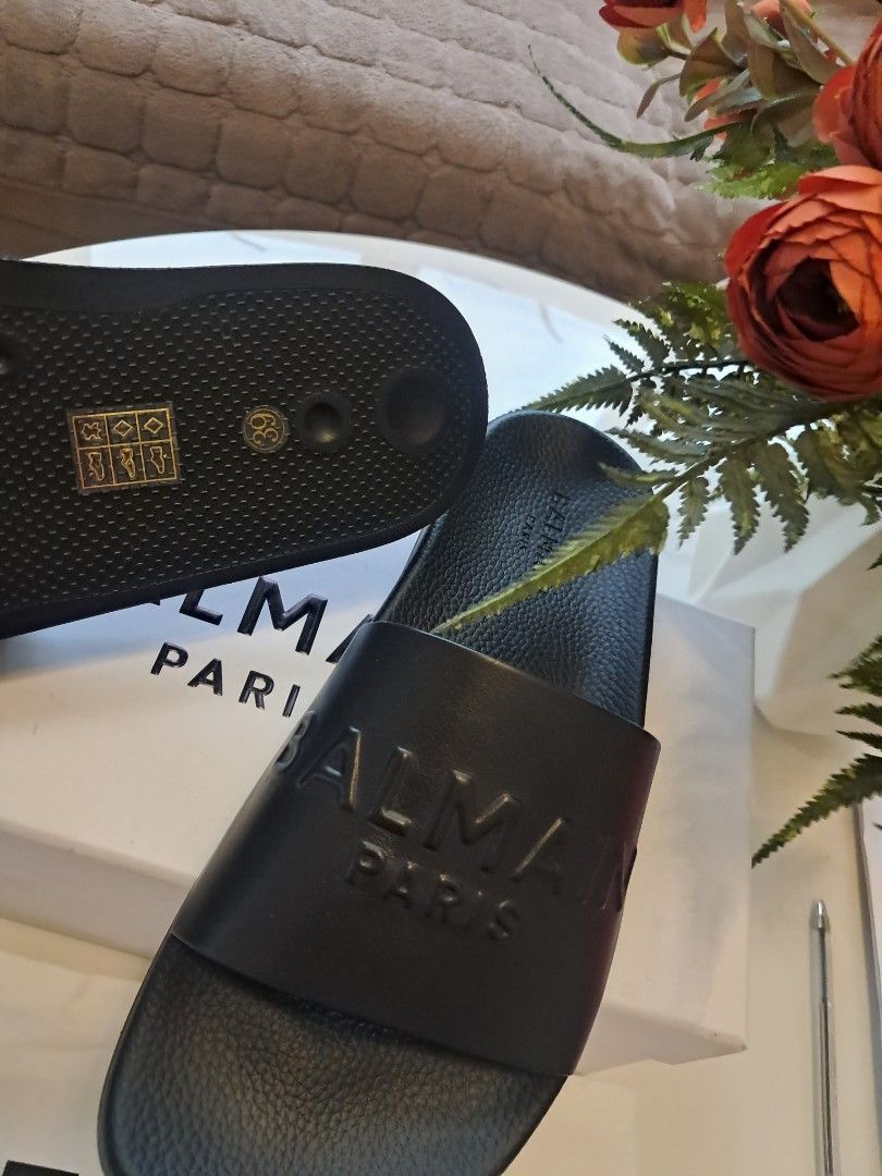 Balmain slides unisex (Category: Slippers & Slides) located in Ibaan. Submitted by ljnaig14 (Listing ID 1460747529, Image 3). Description: Brand: ORIGINAL BALMAIN PARIS Type: Slip-on / slide sandals Color: Black sole/footbed with red wide strap Design: Minimalist, chunky/raised sole, with Balmain branding embossed on the red strap Size:40/41 PRICE:3000.