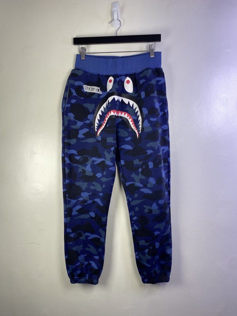 BAPE Blue Camo Shark Face Sweatpants (Category: Joggers) located in Manila. Submitted by declutterpromax (Listing ID 1464620667, Image 1). Description: - Iconic BAPE blue camo sweatpants - Features the signature shark face graphic - Comfortable elastic waistband and cuffs - Two functional back pockets - Ideal for everyday casual wear.