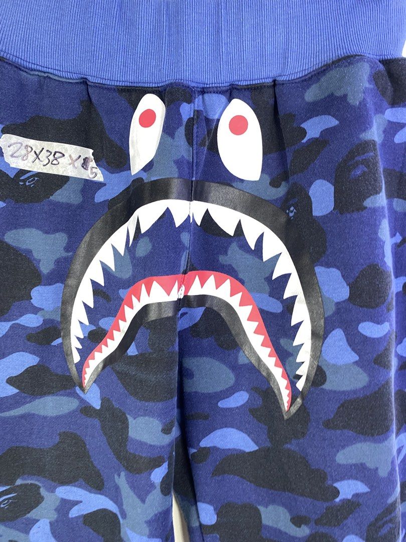 BAPE Blue Camo Shark Face Sweatpants (Category: Joggers) located in Manila. Submitted by declutterpromax (Listing ID 1464620667, Image 2). Description: - Iconic BAPE blue camo sweatpants - Features the signature shark face graphic - Comfortable elastic waistband and cuffs - Two functional back pockets - Ideal for everyday casual wear.