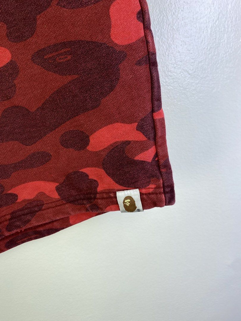 BAPE Red Camo Shark Shorts (Category: Shorts) located in Manila. Submitted by declutterpromax (Listing ID 1464601139, Image 2). Description: - BAPE red camouflage shorts - Iconic shark graphic on the front - Includes APE HEAD logo and WGM graphic - Comfortable sweatshort material - Elastic waistband for a perfect fit.