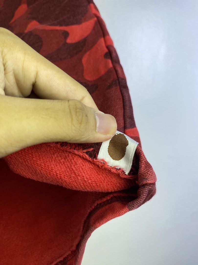 BAPE Red Camo Shark Shorts (Category: Shorts) located in Manila. Submitted by declutterpromax (Listing ID 1464601139, Image 3). Description: - BAPE red camouflage shorts - Iconic shark graphic on the front - Includes APE HEAD logo and WGM graphic - Comfortable sweatshort material - Elastic waistband for a perfect fit.