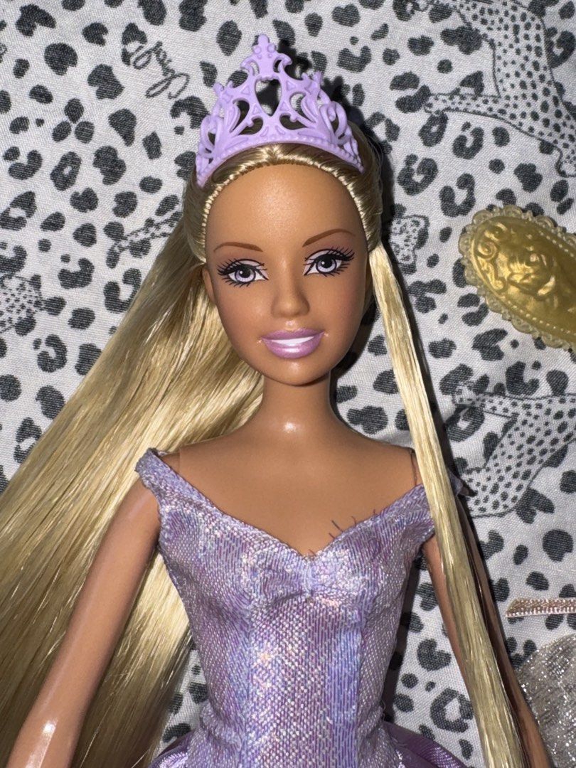 Barbie Rapunzel (Category: Kids Toys) located in Manila. Submitted by poporo.ly (Listing ID 1464642216, Image 2). Description: — almost complete (missing bracelet only) — with 1st and 2nd outfit, crown, heels and hairbrush — the gown has a flaw/torn on the arm sleeve.