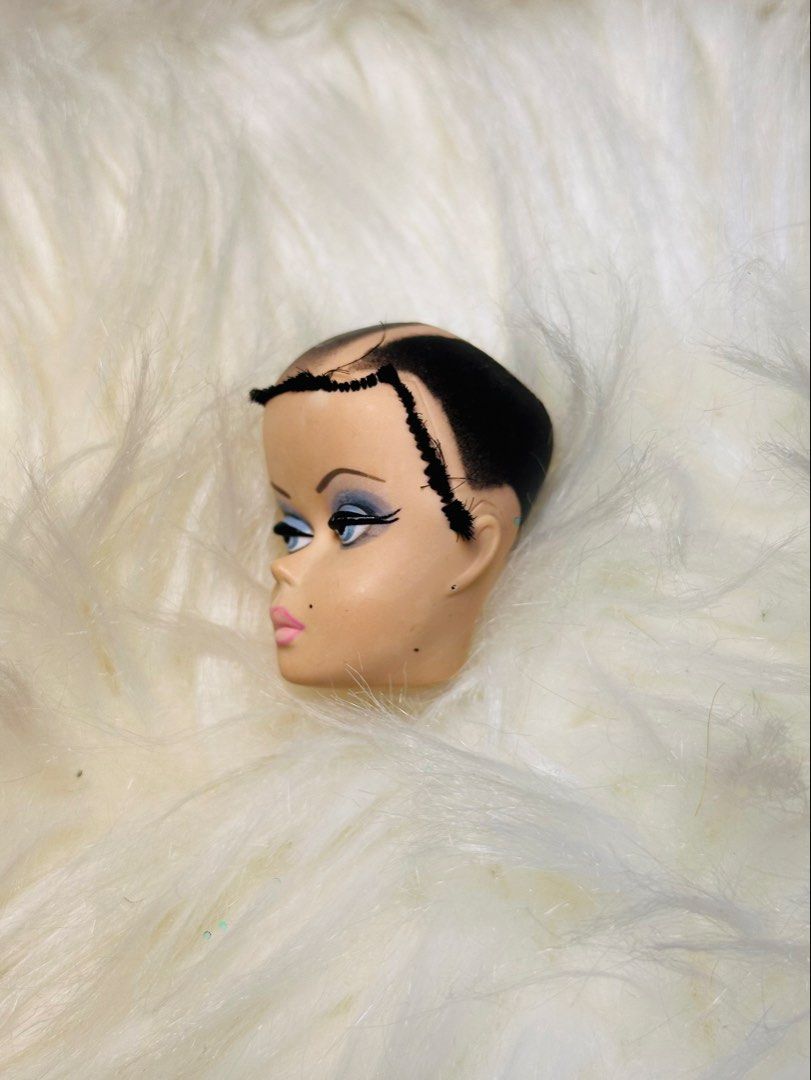 Barbie silkstone head exclusive (Category: Kids Toys) located in Santa Maria. Submitted by houseofluckytoystore (Listing ID 1464751454, Image 3). Description: - Vintage fashion doll head, ideal for custom projects, repairs, or art displays - Features a painted black pixie crop on top with rooted black hair around the sides and back - Striking makeup details including dramatic blue eyeshadow, arched eyebrows, pink lips, and a cheek beauty mark - C