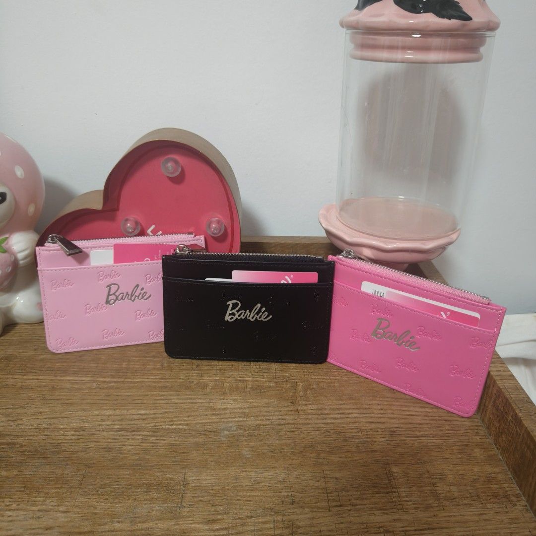 Barbie wallet (Category: Wallets & Card holders) located in Cavite. Submitted by phtmt (Listing ID 1464742313, Image 1). Description: BNEW 450 each cardholders feature the iconic embossed Barbie signature logo and a convenient zippered pocket for your coins and cards..
