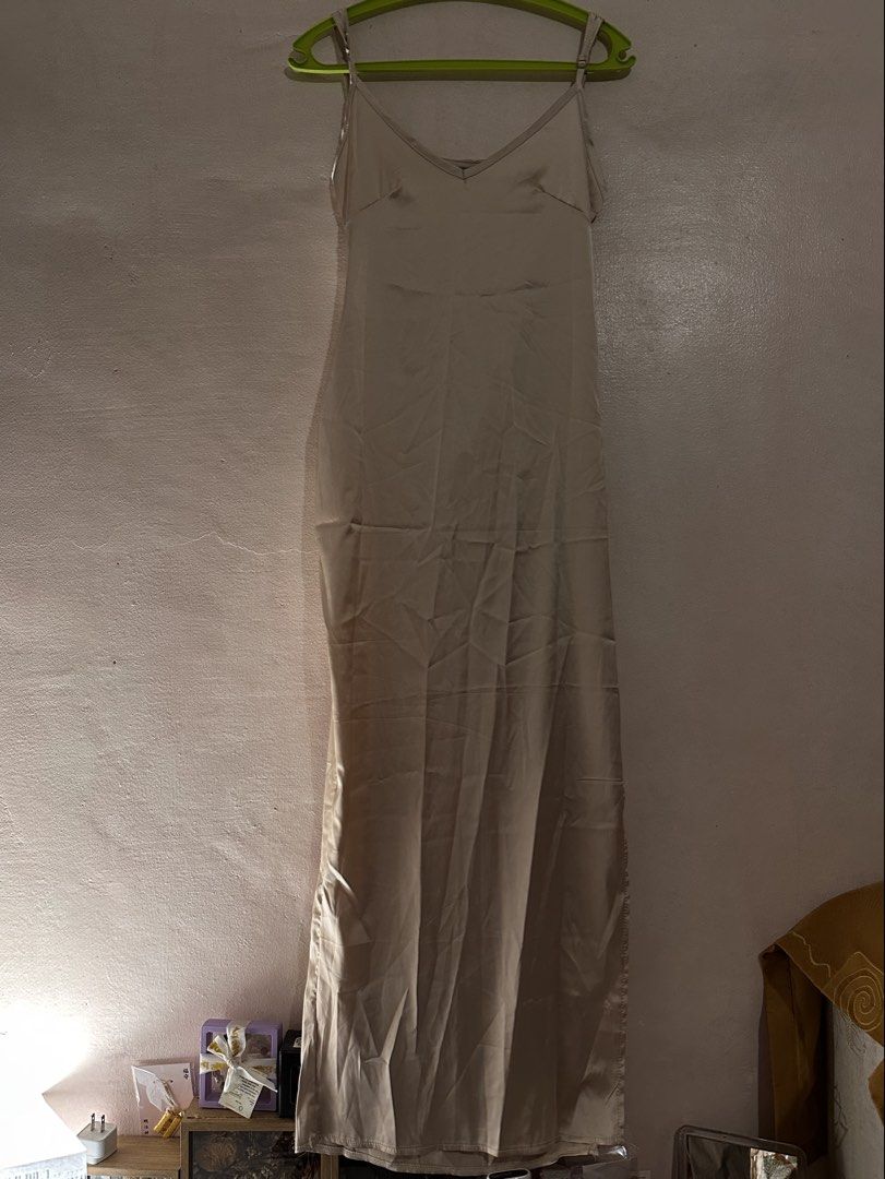 Beige Satin Slip Dress with Low Back (Category: Dresses) located in Paranaque City. Submitted by __rubyjane (Listing ID 1464695780, Image 1). Description: - Color: Elegant champagne beige - Material: Silky fabric with a beautiful drape and smooth finish - Design: Classic spaghetti straps with a stunning deep V-back and delicate back strap details - Length: Midi to maxi (depending on your height) - Versatility: Perfect for dates, events, or stylis
