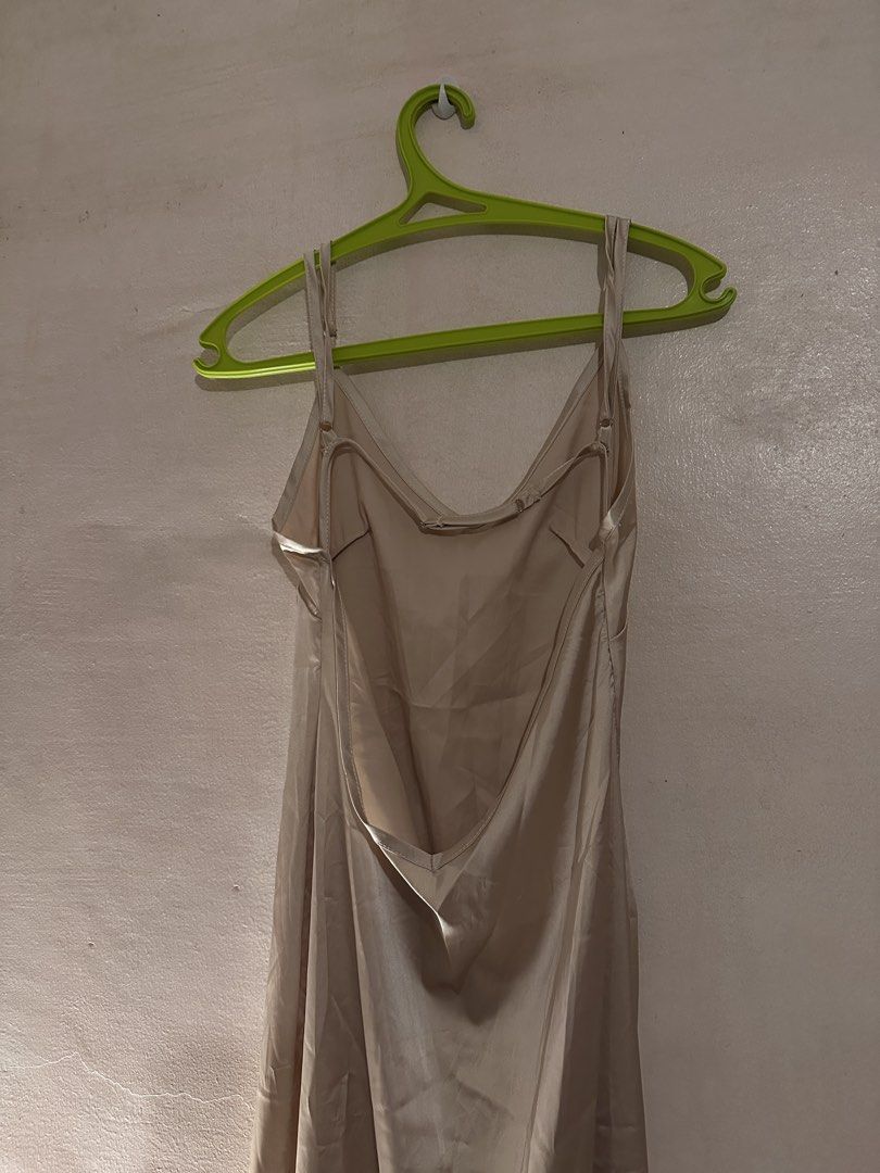 Beige Satin Slip Dress with Low Back (Category: Dresses) located in Paranaque City. Submitted by __rubyjane (Listing ID 1464695780, Image 2). Description: - Color: Elegant champagne beige - Material: Silky fabric with a beautiful drape and smooth finish - Design: Classic spaghetti straps with a stunning deep V-back and delicate back strap details - Length: Midi to maxi (depending on your height) - Versatility: Perfect for dates, events, or stylis