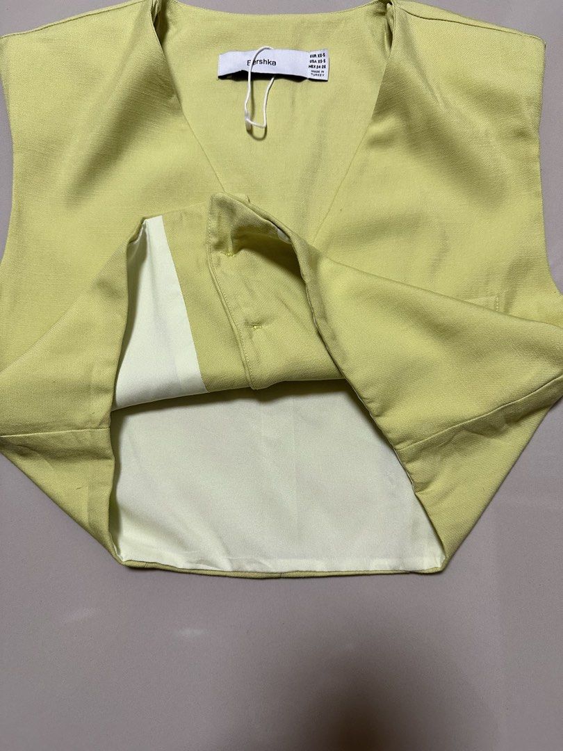 Bershka lime green vest top (Category: Sleeveless) located in Davao. Submitted by theresetshelf (Listing ID 1464644305, Image 2). Description: lime green cropped tailored vest V-neckline front botton bust size 36 Length 17 xs-small on tag.