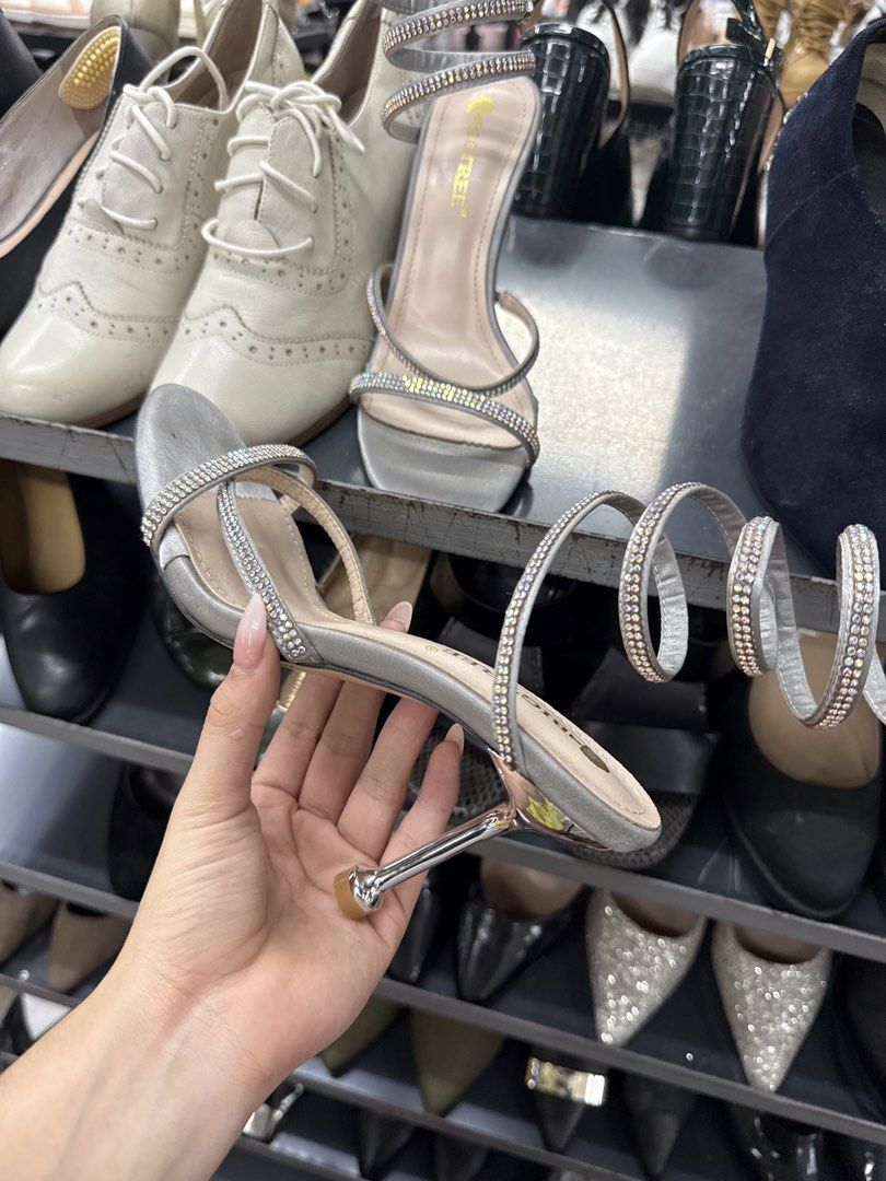 Bigtree Silver Rhinestone Spiral Stiletto Heels (Category: Heels) located in Manila. Submitted by fastlion.584bdf (Listing ID 1464734473, Image 1). Description: - Brand/Model: Bigtree Silver Stiletto Heels - Design: Rhinestone-encrusted wrap-around ankle straps with open toe front - Finish: Metallic silver heels and soles with light beige inner sole - Style: Slip-on wrap style - Occasion: Perfect eye-catching party shoes for events and nights out