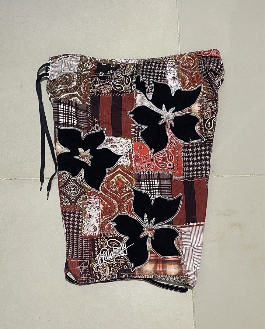 Billabong Patchwork Floral Board Shorts Swim Trunks 34 (Category: Swim Trunks & Board Shorts) located in Manila. Submitted by micoletszx81430 (Listing ID 1464700294, Image 2). Description: - Brand: Billabong - Style: Patchwork board shorts with mixed paisley, plaid, and floral hibiscus appliques - Colorway: Red, white, black, and brown - Features: Drawstring waistband with black laces and side cargo pocket with branded pull tab - Measurements: 34