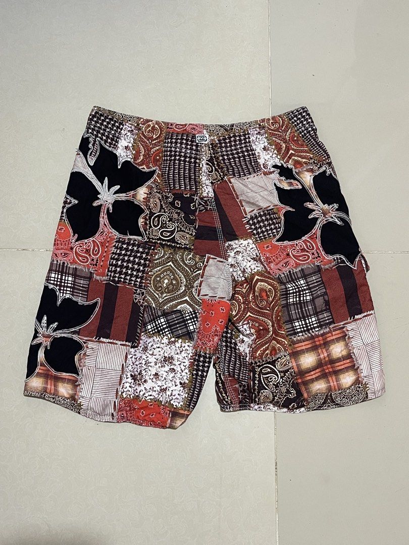 Billabong Patchwork Floral Board Shorts Swim Trunks 34 (Category: Swim Trunks & Board Shorts) located in Manila. Submitted by micoletszx81430 (Listing ID 1464700294, Image 3). Description: - Brand: Billabong - Style: Patchwork board shorts with mixed paisley, plaid, and floral hibiscus appliques - Colorway: Red, white, black, and brown - Features: Drawstring waistband with black laces and side cargo pocket with branded pull tab - Measurements: 34