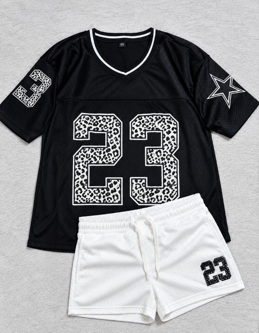 Black and White Jersey Set Size XS (Category: Sets or Coordinates) located in Las Pinas. Submitted by alkwinuts (Listing ID 1464765437, Image 1). Description: - 2-piece athletic mesh set in black and white - V-neck top with large leopard print '23' and star/number sleeve graphics - Matching white mesh shorts with adjustable drawstring waist and '23' print - Lightweight, breathable fabric ideal for sporty or casual streetwear - Size: XS.