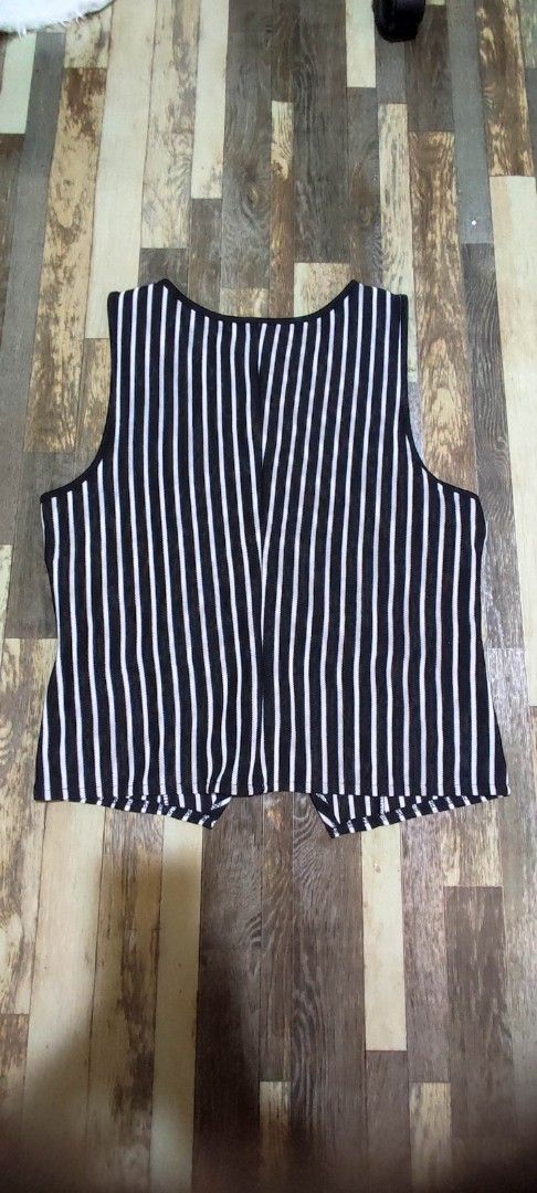 Black and White Striped Sleeveless Vest (Category: Sleeveless) located in Quezon City. Submitted by tintinarms (Listing ID 1464621994, Image 3). Description: - Classic black and white stripe pattern - Sleeveless vest design - Two functional front pockets - Button-down closure - Slightly cropped cut - Ideal for layering over tops or dresses - Versatile for smart casual outfits.