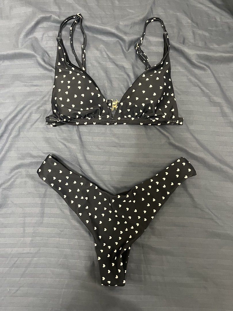Black Bikini with White Hearts (Category: Bikinis & Swimsuits) located in Makati City. Submitted by samsafsav (Listing ID 1464598563, Image 1). Description: - Triangle top with adjustable straps and a clasp closure - Thong-style bottoms - Non-removable pads Size: Small RFS: Decluttering.
