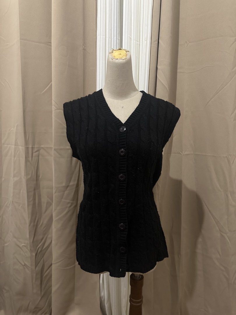 Black Cable Knit V-Neck Button-Up Cardigan Vest (Category: Coats, Jackets and Outerwear) located in Taguig. Submitted by kokombeer (Listing ID 1464685977, Image 1). Description: - Black cable knit vest - V-neckline - Button-up front - Sleeveless design - Ideal for layering - Adds warmth without bulk - Versatile for dressing up or down.