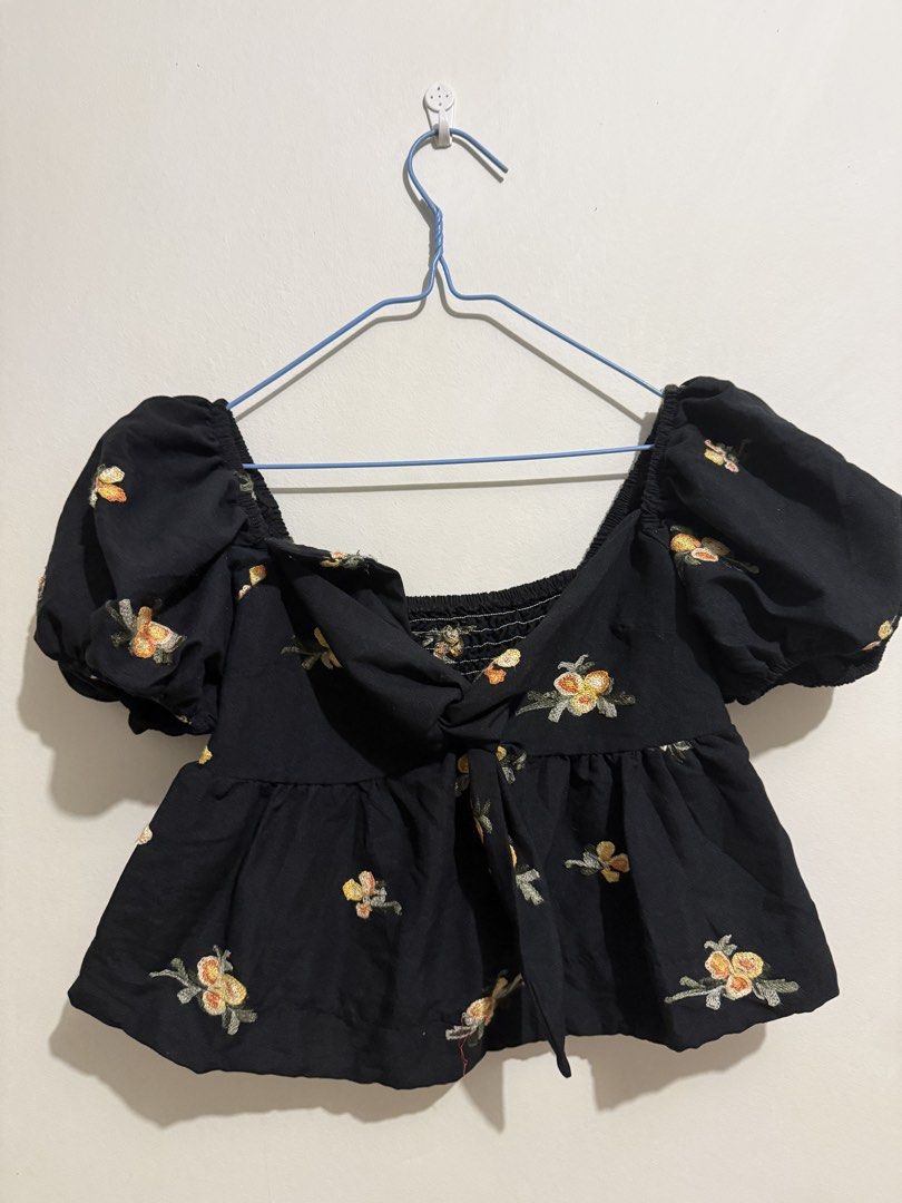 Black Embroidered Puff Sleeve Tie Front Top (Category: Blouses) located in San Fernando. Submitted by richeloy (Listing ID 1464572284, Image 1). Description: - Cute black top - Yellow and orange floral embroidery - Puff sleeves - Tie front detail - Smocked back for a comfortable fit - Peplum hemline - Perfect for casual or night out.