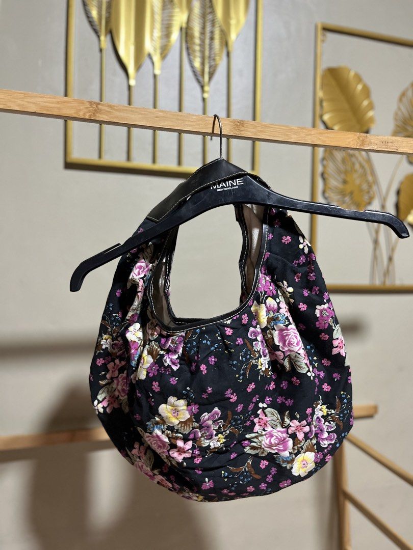 Black Floral Shoulder Bag (Category: Shoulder Bags) located in Caloocan City. Submitted by decluttering.101_ (Listing ID 1464622219, Image 1). Description: - Chic black shoulder bag with a vibrant floral design. - Secure magnetic snap closure. - Convenient interior zip pocket for organization. - Stylish black faux leather straps. - Spacious enough for all your daily essentials. - Ideal for everyday wear and casual outings..
