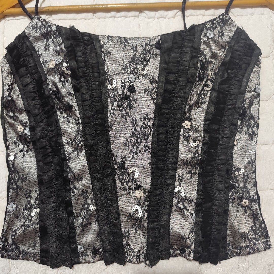 Black lace corset style cami top (Category: Sleeveless) located in Bacolod City. Submitted by dearicawho.56 (Listing ID 1464711946, Image 2). Description: - Black and silver lace cami top - Structured vertical satin ruffles on the front - Thin spaghetti straps - Full-length zipper closure at the back - Ultimate Y2K aesthetic style for going out 🧾Mode of payment: 💙Gcash 💚GoTyme 🖤Maya 📍 Bacolod City. Negros Occidental .