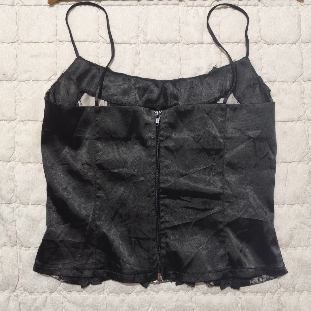 Black lace corset style cami top (Category: Sleeveless) located in Bacolod City. Submitted by dearicawho.56 (Listing ID 1464711946, Image 3). Description: - Black and silver lace cami top - Structured vertical satin ruffles on the front - Thin spaghetti straps - Full-length zipper closure at the back - Ultimate Y2K aesthetic style for going out 🧾Mode of payment: 💙Gcash 💚GoTyme 🖤Maya 📍 Bacolod City. Negros Occidental .
